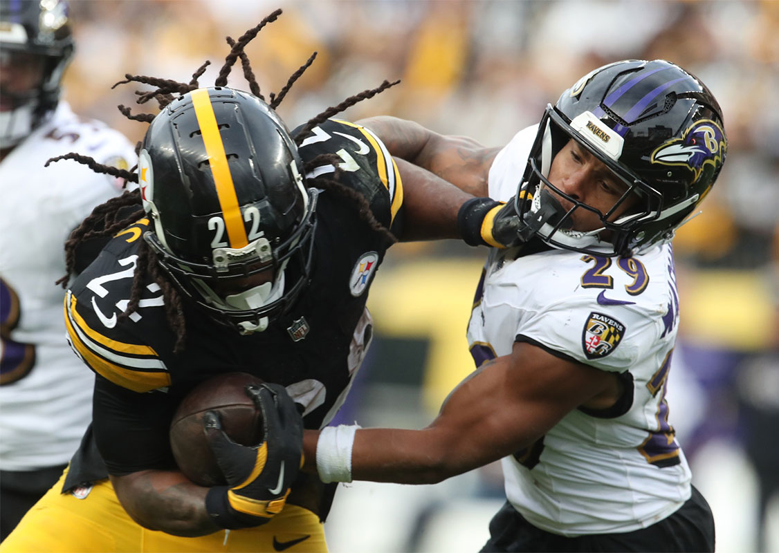 Pittsburgh Steelers running back Najee Harris (22) carries the ball against Baltimore Ravens safety Ar'Darius Washington (29) during the fourth quarter at Acrisure Stadium.