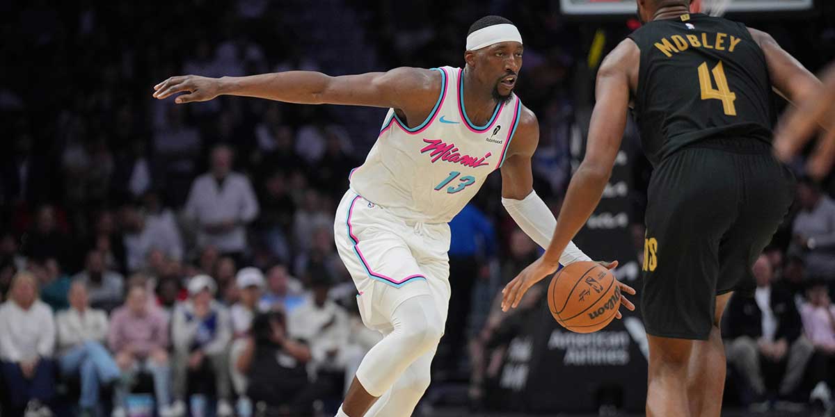 Miami Heat Center Bam Adebaiio (13) brings the ball in court as Cleveland Cavaliers Next Evan Moblei (4) in the second half in the center of Kaseya.