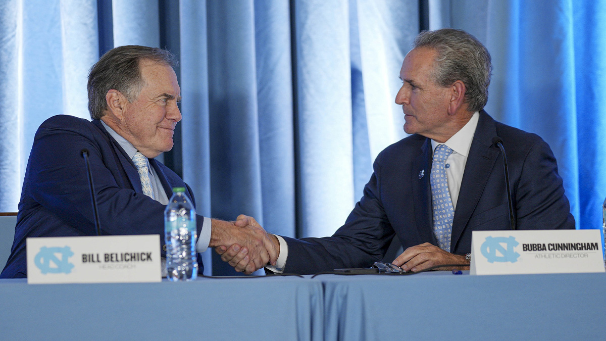 Dec 12, 2024; Chapel Hill, NC, USA; North Carolina Tar Heels new head coach Bill Belichick shakes hands with athletic director Bubba Cunningham at Loudermilk Center for Excellence. Mandatory Credit: Jim Dedmon-Imagn Images