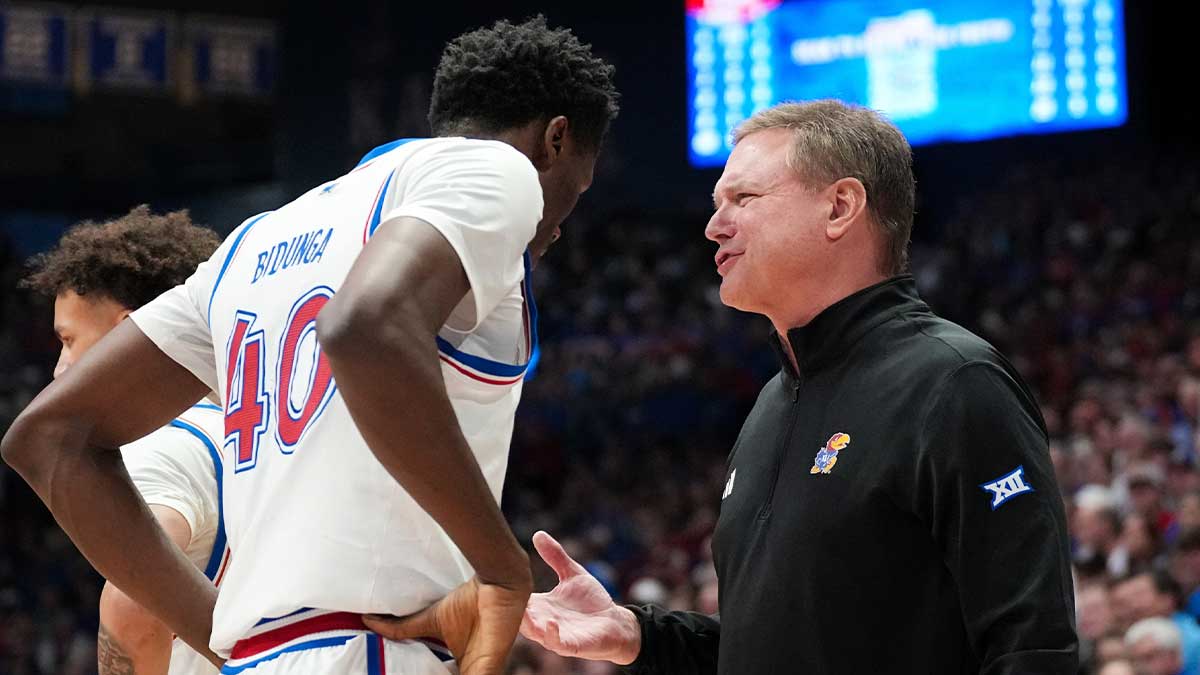 January 25, 2025; Lawrence, Kansas, USA; Kansas Jayhawks coach Bill Self talks with forward Flori Bidung (40) during a timeout against the Houston Cougars during the first half at Allen Fieldhouse. Mandatory credit: Danny Medley-Imagn Images