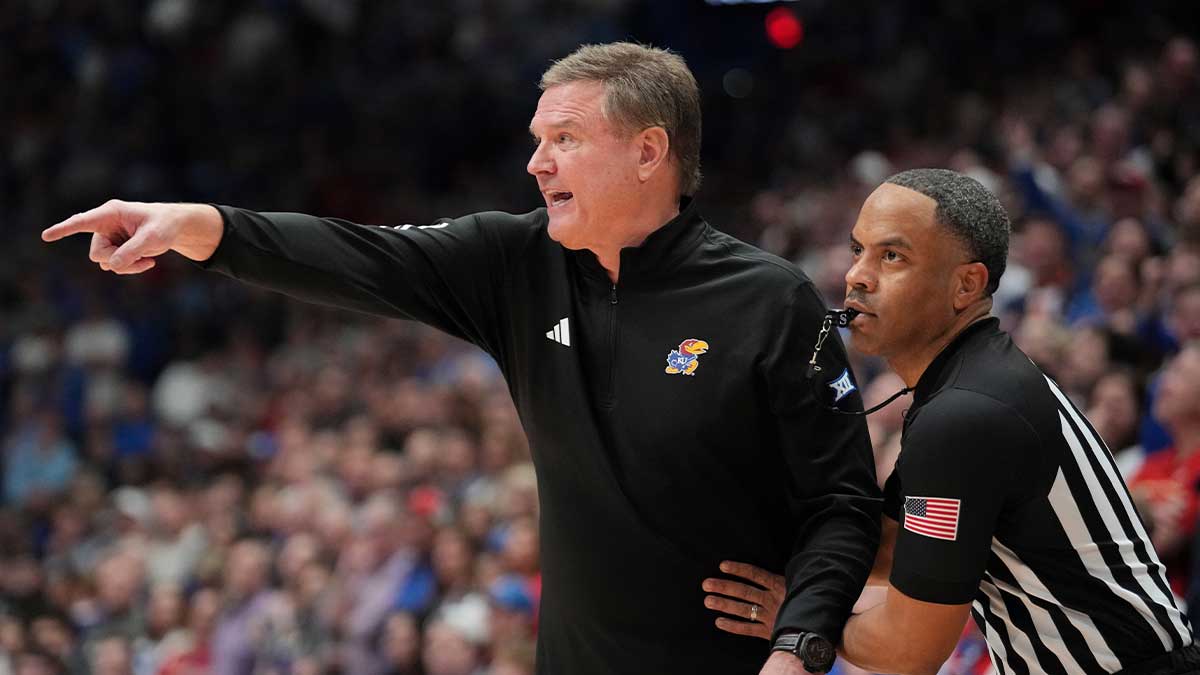 Jan 25, 2025; Lawrence, Kansas, USA; An official restrains Kansas Jayhawks head coach Bill Self against the Houston Cougars during overtime at Allen Fieldhouse. Mandatory Credit: Denny Medley-Imagn Images