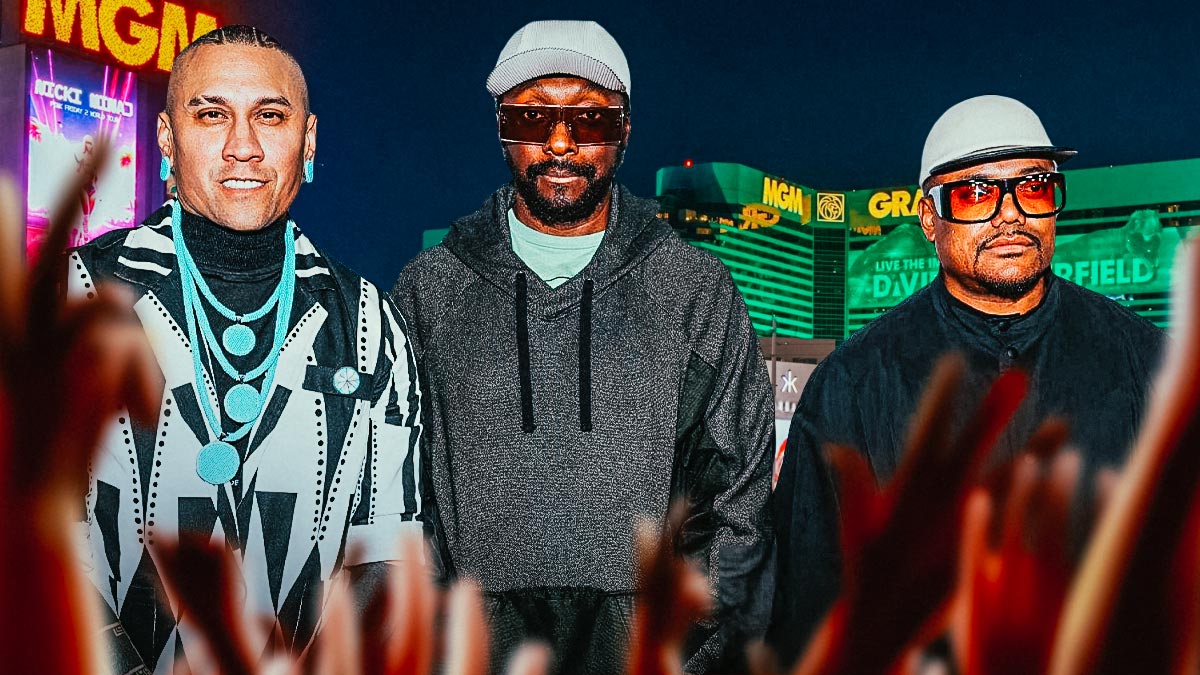 The Black Eyed Peas members Will.I.Am, Apl.De.Ap, and Taboo with Las Vegas strip behind them.