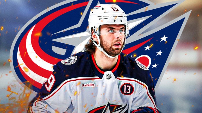 Adam Fantilli with fire around him looking happy, Columbus Blue Jackets logo, hockey rink in background