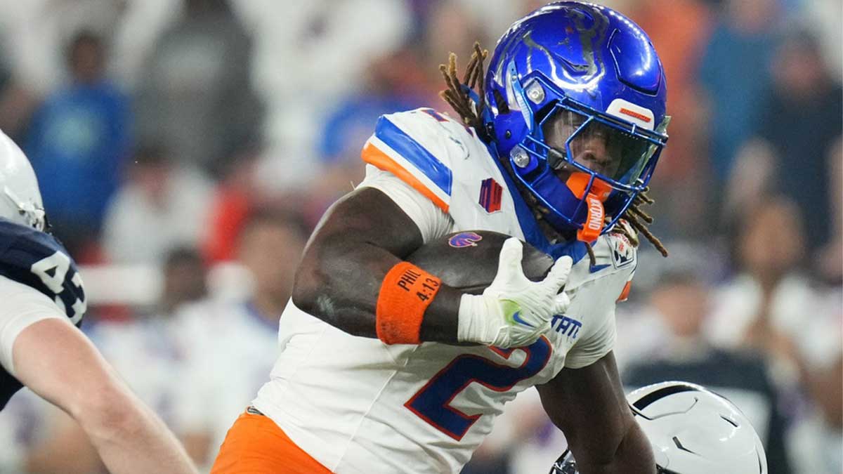 Boise State Broncos running back (2) Ashton Jeanty tries to break past Penn State Nittany Lions safety Zakee Wheatley (6) during their Vrbo Fiesta Bowl matchup at State Farm Stadium.