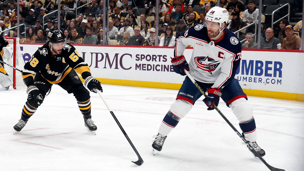 Columbus Blue Jackets Center Boone Jenner (38) Moves Puttsburgh Penguins DefenseMan Kris Letang (58) during the second period on PPG Baints Arena. 