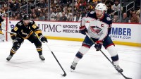 Columbus Blue Jackets center Boone Jenner (38) moves the puck against Pittsburgh Penguins defenseman Kris Letang (58) during the second period at PPG Paints Arena.