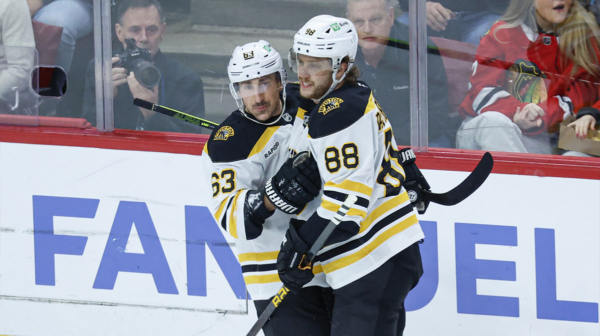 Boston Bruins left wing Brad Marchand (63) celebrates with right wing David Pastrnak (88) after scoring against the Chicago Blackhawks during the second period at United Center.