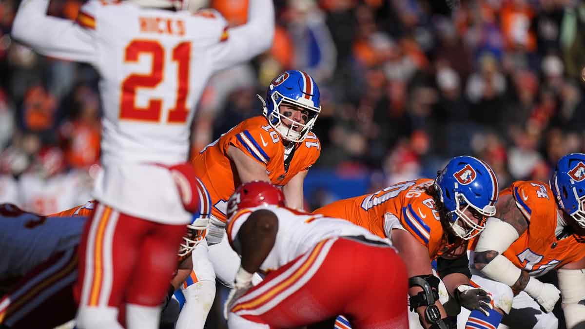 Denver Broncos quarterback Bo Nix (10) at the line of scrimmage during the first quarter against the Kansas City Chiefs at Empower Field at Mile High.