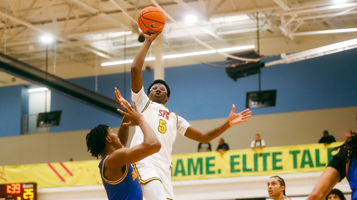 Bryce James (5) looks to float the ball against Team Boo Williams during the Nike Elite Youth Basketball League session one on Friday