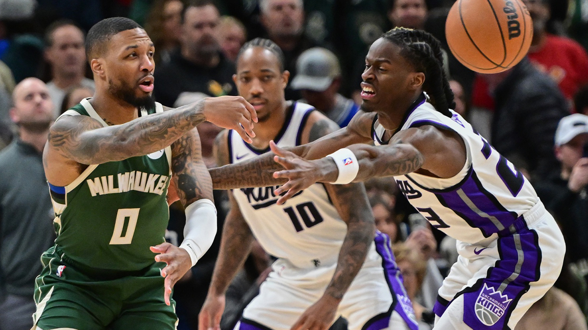 Bucks guard Damian Lillard (0) passes the ball from Sacramento Kings forward DeMar DeRozan (10)