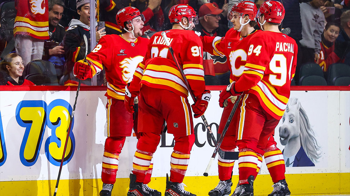 Calgary Flames left wing Jakob Pelletier (22) celebrates his goal with teammates against the Buffalo Sabres during the third period at Scotiabank Saddledome.