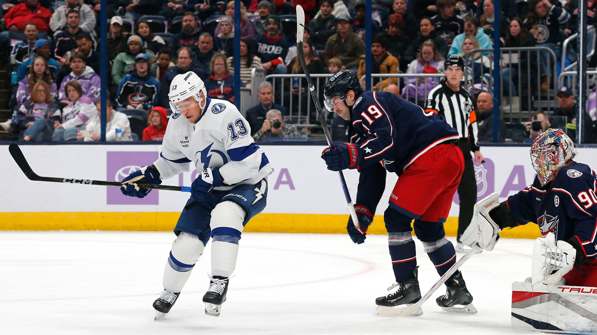Tampa Bay Lightning right wing Cam Atkinson (13) deflects the puck past Columbus Blue Jackets goalie Elvis Merzlikins (90) for a gaol during the first period at Nationwide Arena.