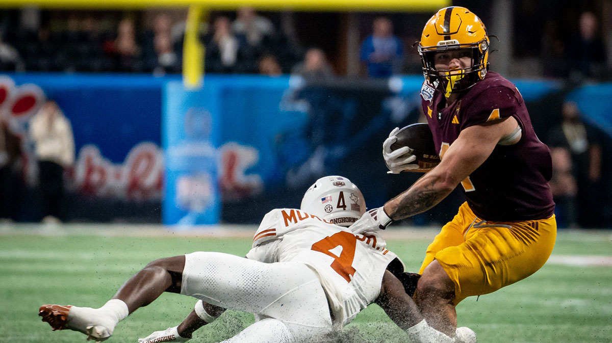 Texas Longhorns defensive back Andrew Mukuba (4) dives to tackle Arizona State Sun Devils running back Cam Skattebo (4) during the first overtime period as the Texas Longhorns play the Arizona State Sun Devils in the Peach Bowl College Football Playoff quarterfinal at Mercedes-Benz Stadium