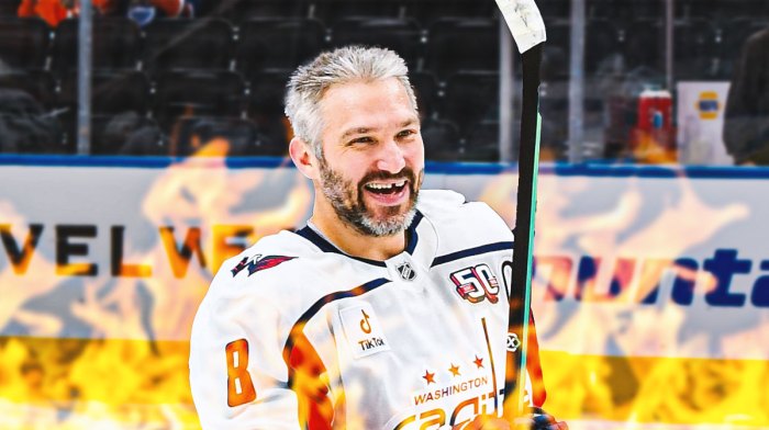 Alex Ovechkin looking happy with fire around him, Washington Capitals logo, hockey rink in background