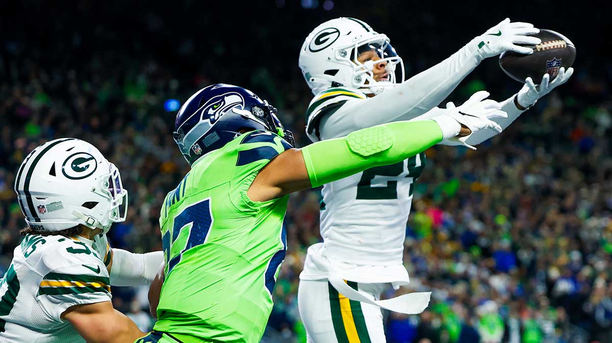 Green Bay Packers cornerback Carrington Valentine (24) intercepts a pass against Seattle Seahawks tight end Noah Fant (87) during the second quarter at Lumen Field.