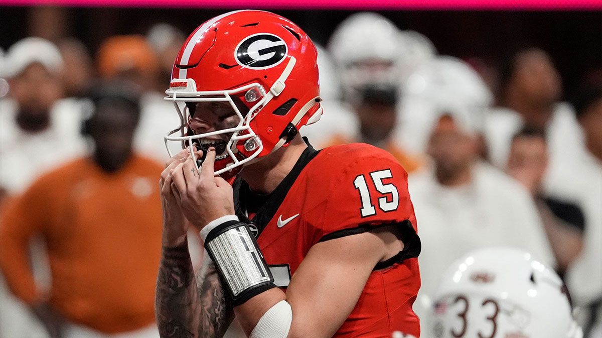 Georgia quarterback Carson Beck (15) putts in his mouth grad on the final play during overtime of the SEC championship game against Texas in Atlanta, on Saturday, Dec. 7, 2024.