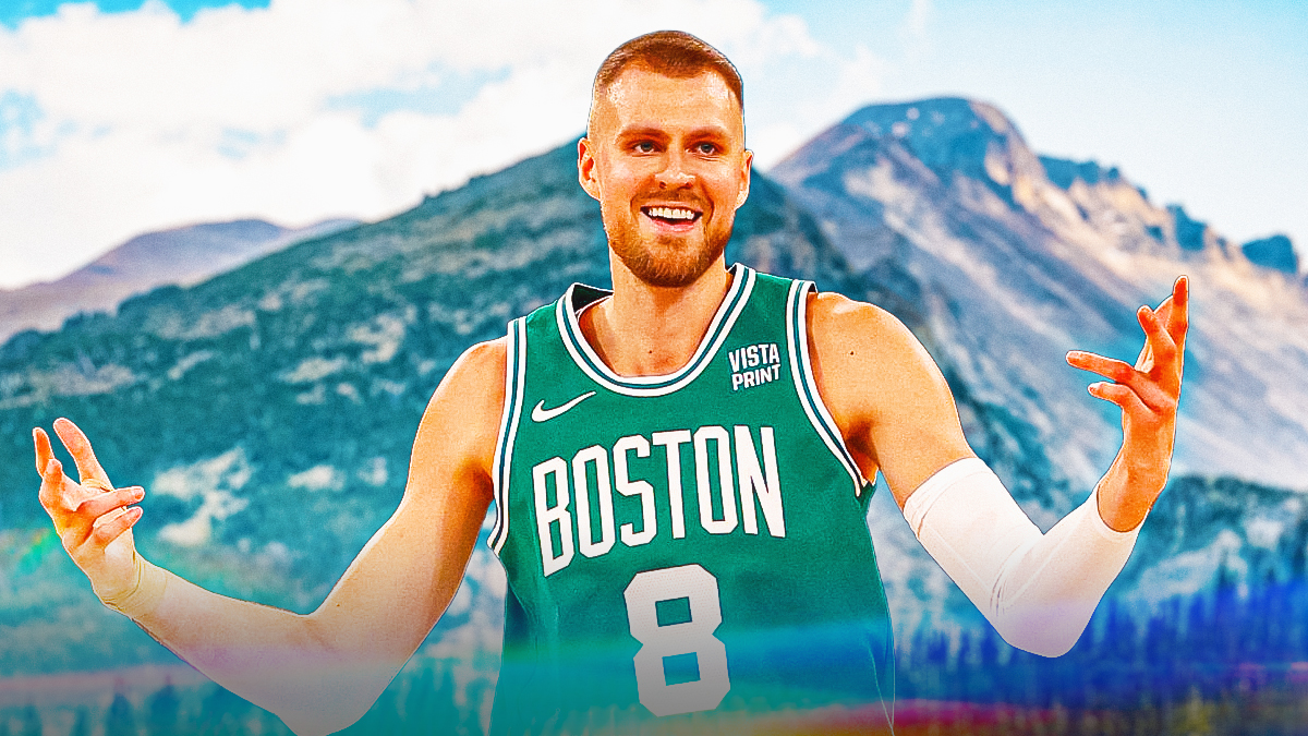 Kristaps Porzingis looking hyped/happy on a Denver mountain background