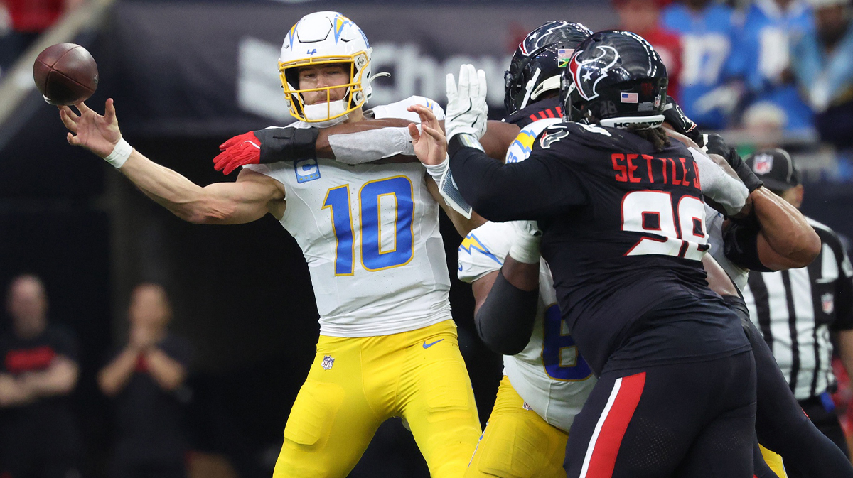     Los Angeles Chargers quarterback Justin Herbert (10) passes during the second quarter against the Houston Texans in the AFC wild card game at NRG Stadium. 