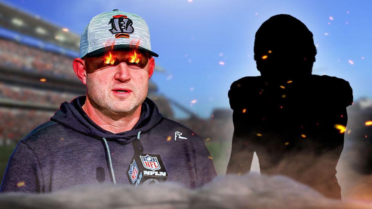 Bengals executive Duke Tobin looking angry with fire in his eyes standing next to SILHOUETTE of Bengals WR Jermaine Burton. Background is Paycor Stadium.