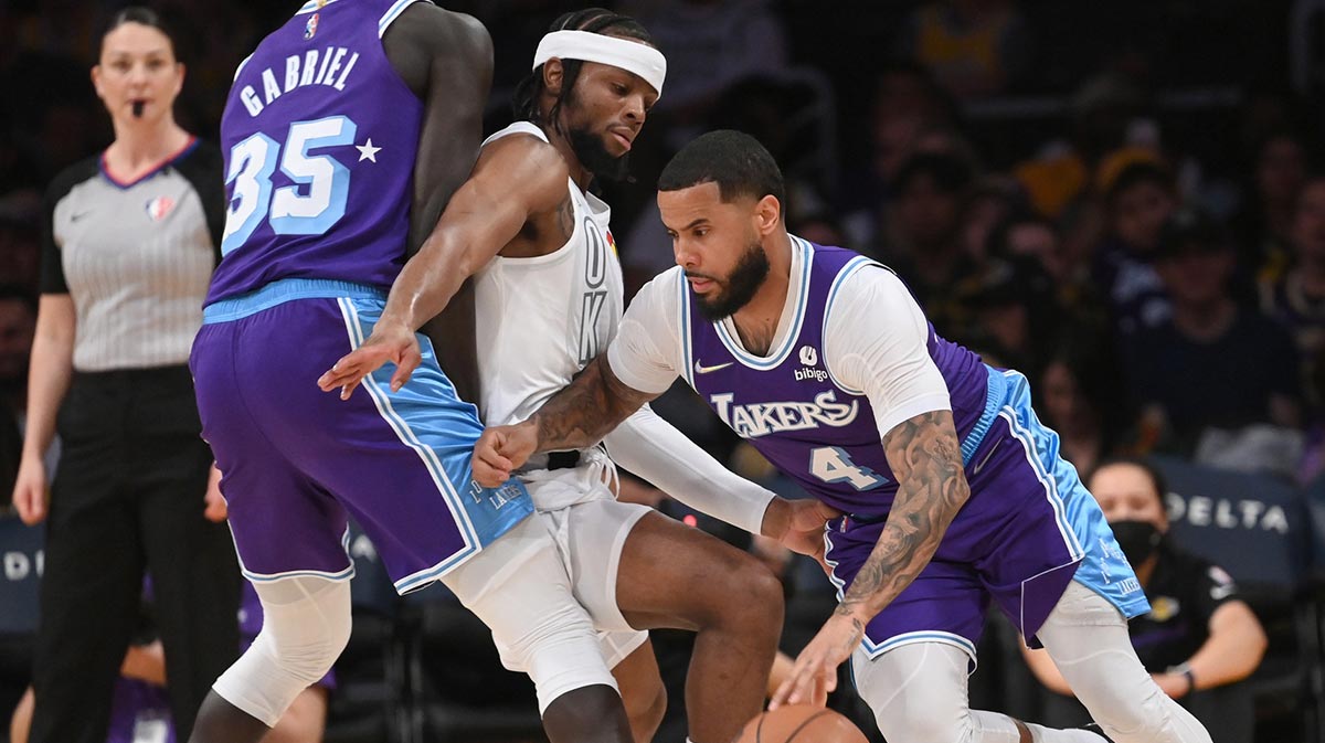 Los Angeles Lakers forward Wenyen Gabriel (35) sets a screen on Oklahoma City Thunder guard Zavier Simpson (9) as Los Angeles Lakers guard D.J. Augustin (4) drives to the basket in the first half at Crypto.com Arena.