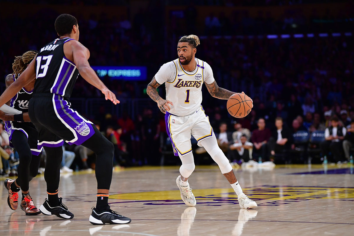 Los Angeles Lakers guard D'Angelo Russell (1) moves the ball against Sacramento Kings forward Keegan Murray (13) during the second half at Crypto.com Arena.