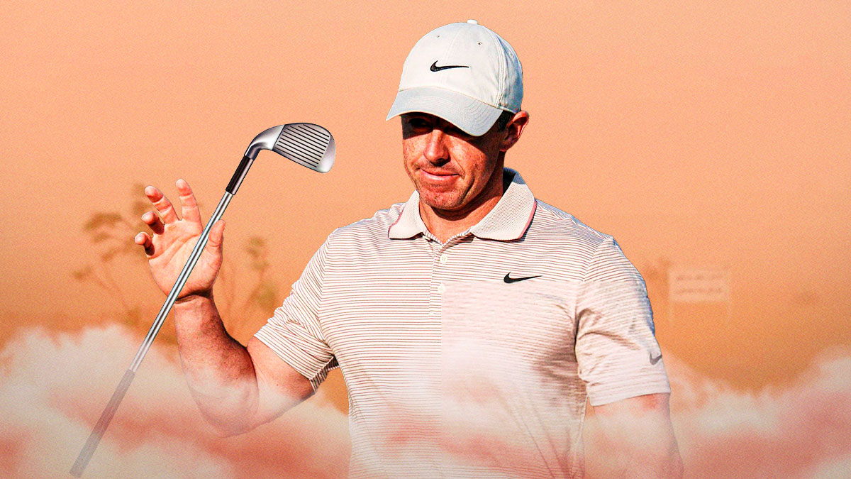 rory mcilroy in sand storm with golf club in hands