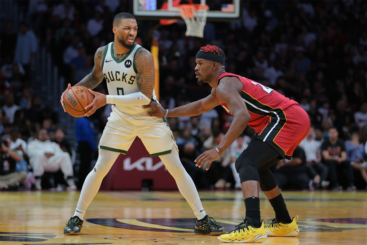 Milwaukee Bucks guard Damian Lillard (0) protects the basketball from Miami Heat forward Jimmy Butler (22) during the third quarter at Kaseya Center. 