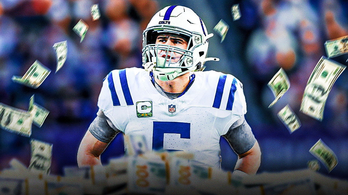 Daniel Jones surrounded by piles of cash.