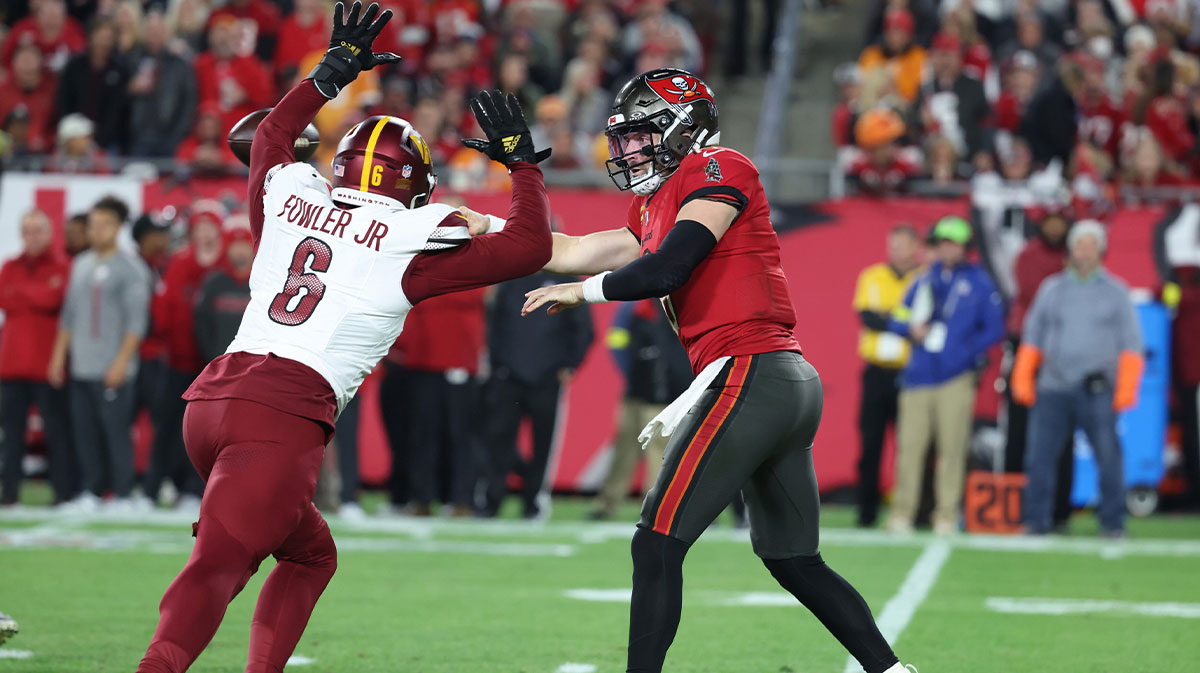 Tampa Bay Buccaneers quarterback Baker Mayfield (6) throws against Washington Commanders linebacker Dante Fowler Jr. (6) during the third quarter of a NFC wild card playoff at Raymond James Stadium.