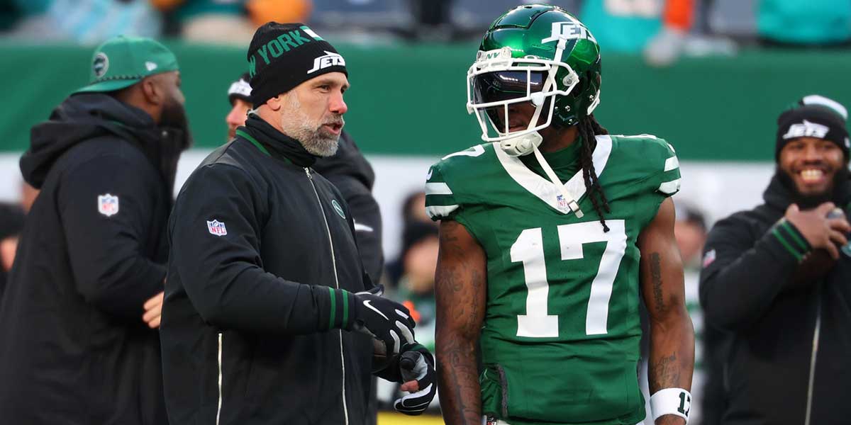 New York Jets interim head coach Jeff Ulbrich speaks with wide receiver Davante Adams (17) during pregame warmups for their game against the Miami Dolphins at MetLife Stadium