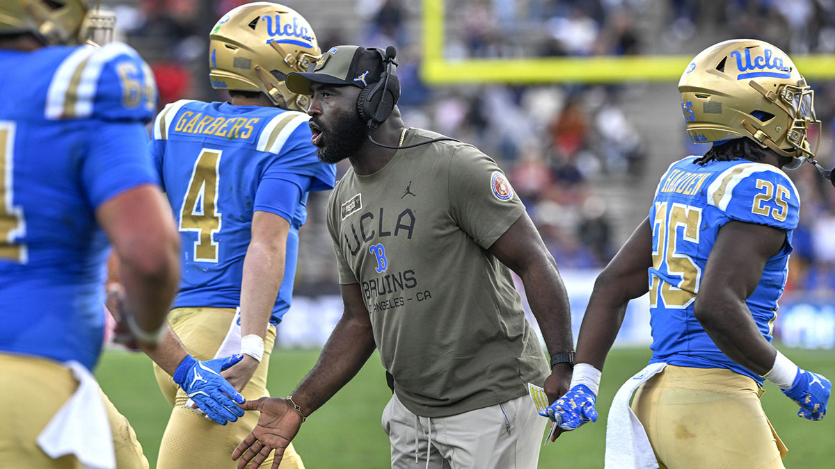 UCLA Bruins head coach DeShaun Foster greets his players after a Bruins touchdown against the Fresno State Bulldogs in the third quarter at Rose Bowl.