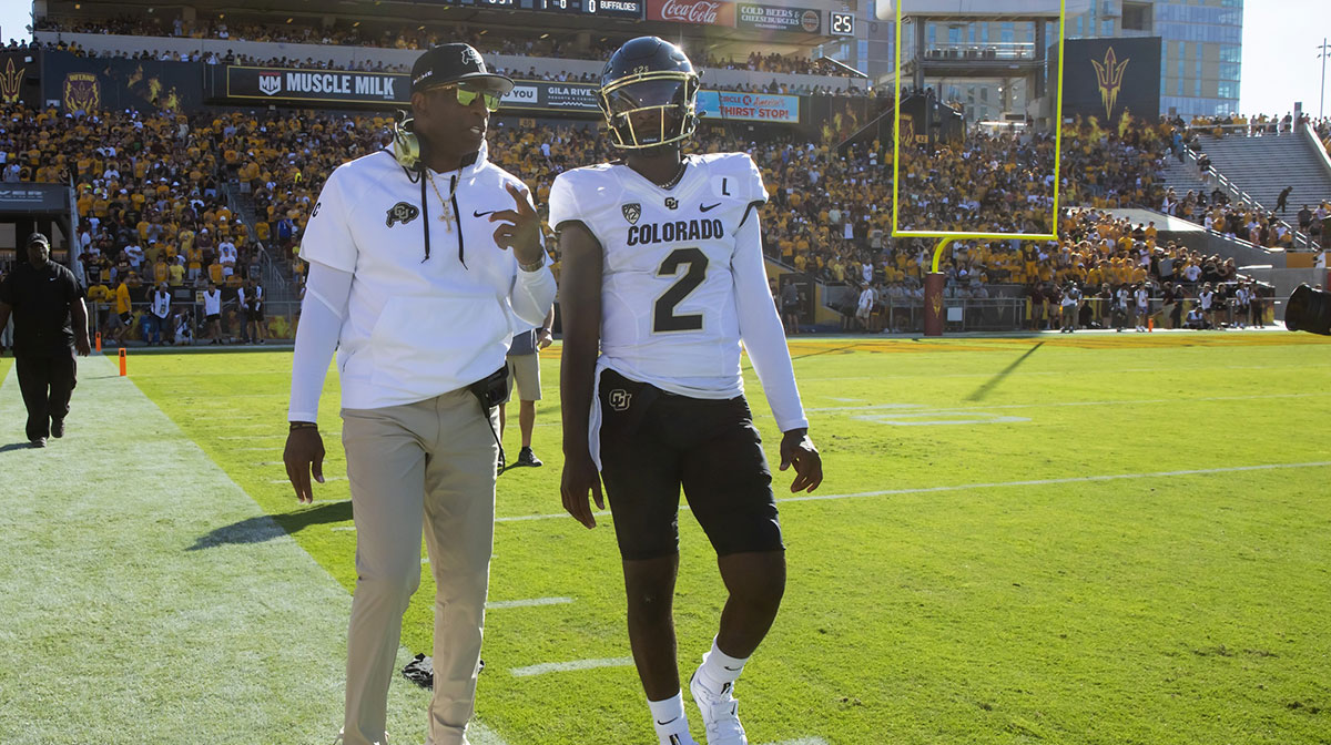 Colorado Buffaloes head coach Deion Sanders with son and quarterback Shedeur Sanders (2) against the Arizona State Sun Devils at Mountain America Stadium.