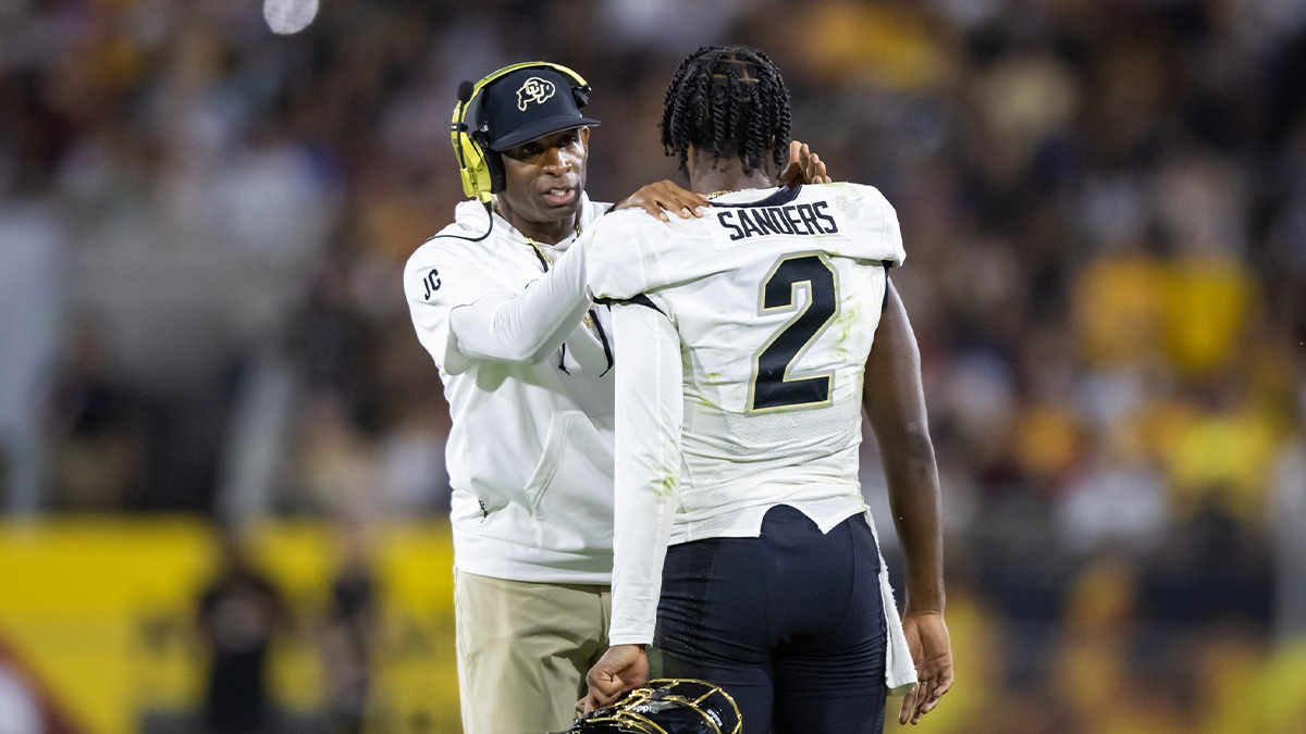 Colorado Buffaloes head coach Deion Sanders with son and quarterback Shedeur Sanders (2) against the Arizona State Sun Devils at Mountain America Stadium.