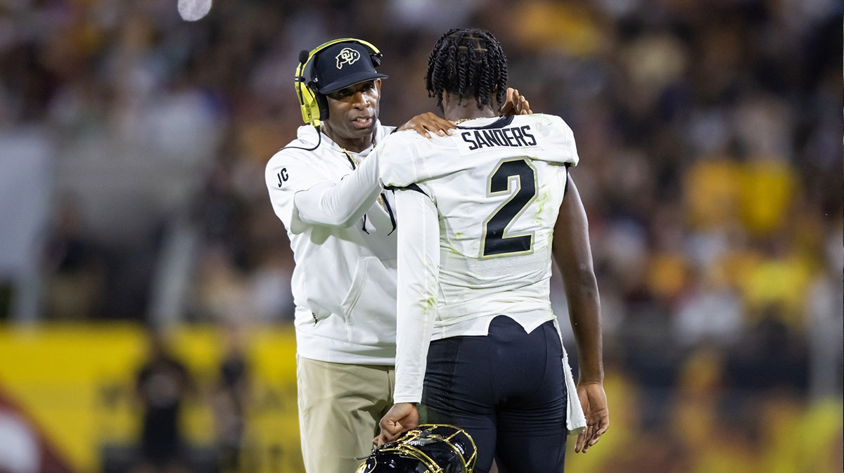 Colorado Buffaloes head coach Deion Sanders with son and quarterback Shedder Sanders, 2, against the Arizona State Sun Devils at Mountain America Stadium.