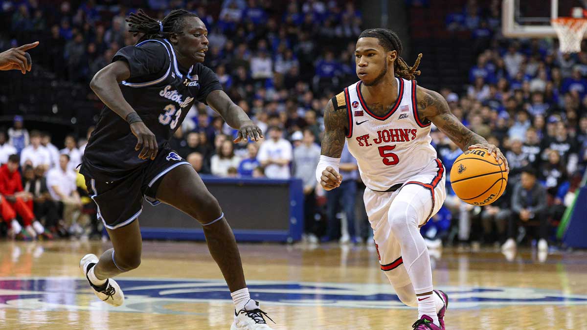 St. John's Red Storm guard Deivon Smith (5) goes to the basket asSeton Hall Pirates guard Garwey Dual (33) defends during the first half at Prudential Center.