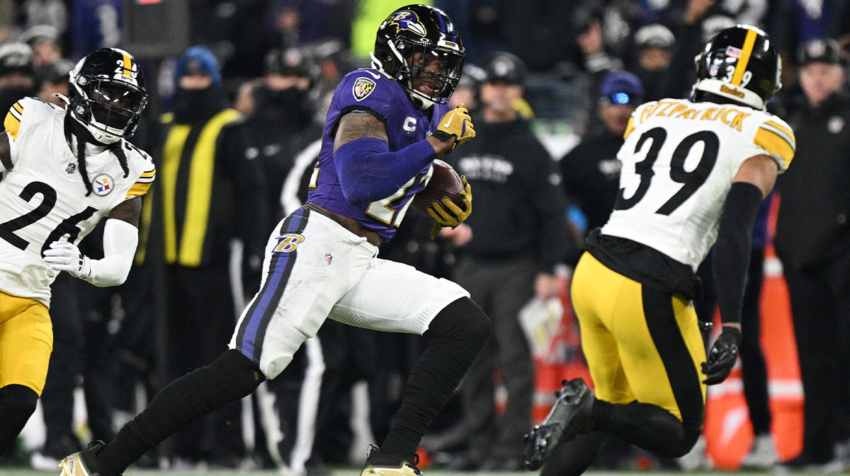 January 11, 2025; Baltimore, Maryland, USA; Baltimore Ravens running back Derrick Henry (22) runs against Minkah Fitzpatrick (39) in the second quarter in the AFC wild-card game at M&T Bank Stadium. 