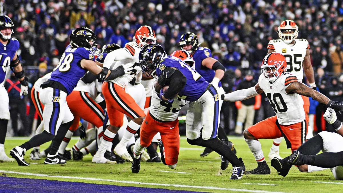 Jan 4, 2025; Baltimore, Maryland, USA; Baltimore Ravens running back Derrick Henry (22) makes a touch down as Cleveland Browns linebacker Mohamoud Diabate (43) is unable to block during the fourth quarter at M&T Bank Stadium. Mandatory Credit: Tommy Gilligan-Imagn Images