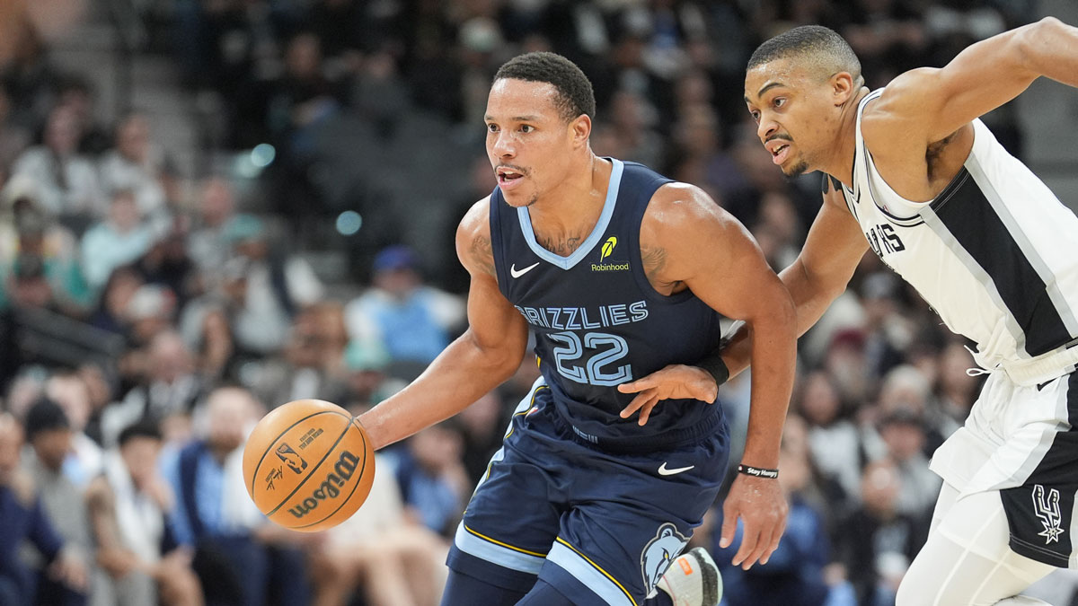 Memphis Grizzlies guard Desmond Bain (22) dribbles past San Antonio Spurs forward Keldon Johnson (0) in the first half at Frost Bank Center.