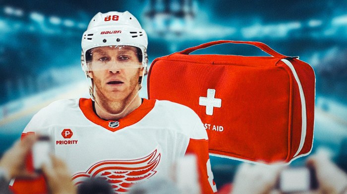 Patrick Kane looking stern, first aid kit, hockey rink in background Detroit Red Wings