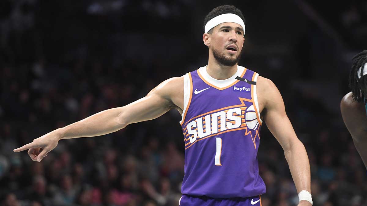 Phoenix Suns guard Devin Booker (1) signals to his team during the first half against the Charlotte Hornets at the Spectrum Center.