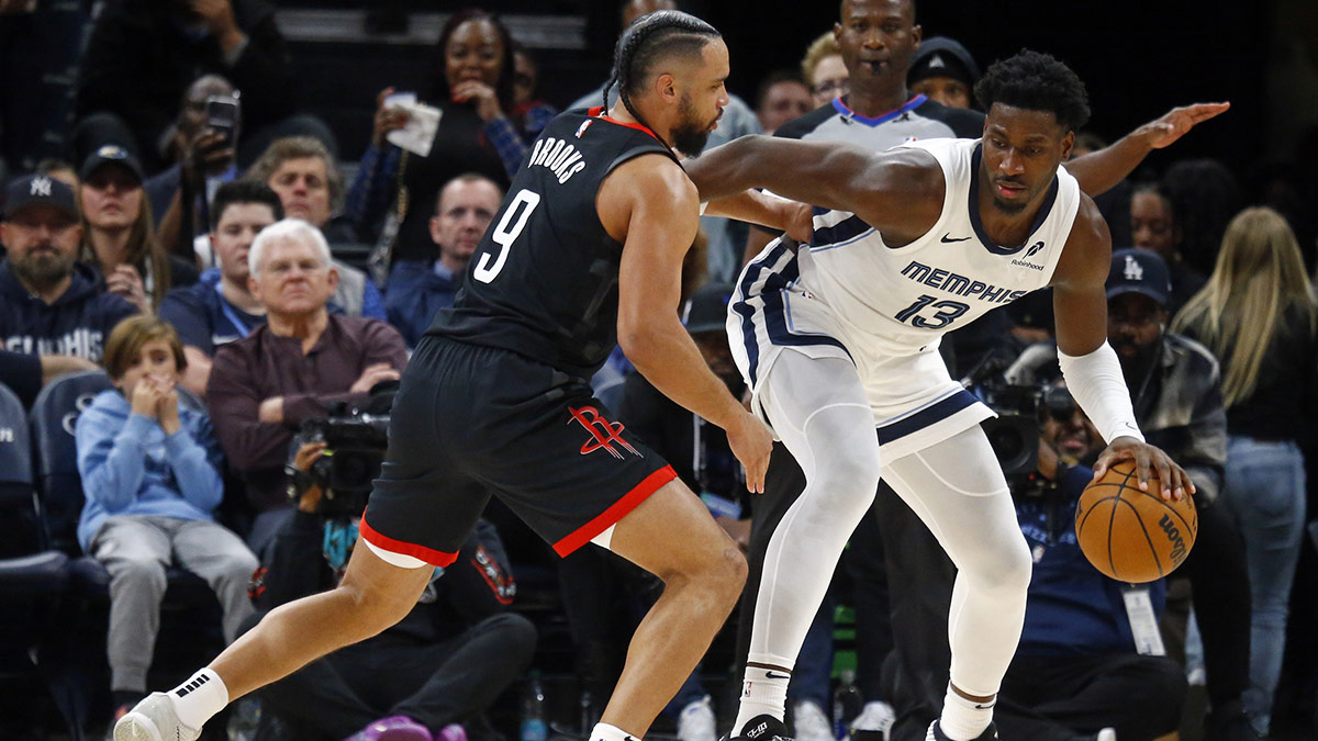 Memphis Grizzlies forward Jaren Jackson Jr. (13) dribbles as Houston Rockets forward Dillon Brooks (9) defends during the fourth quarter at FedExForum.