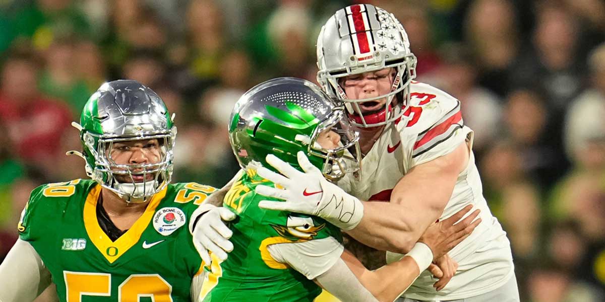 Ohio State Buckeyes defensive end Jack Sawyer (33) hits Oregon Ducks quarterback Dillon Gabriel (8) during the second half of the College Football Playoff quarterfinal at the Rose Bowl in Pasadena, Calif. on Jan. 1, 2025. Ohio State won 41-21.