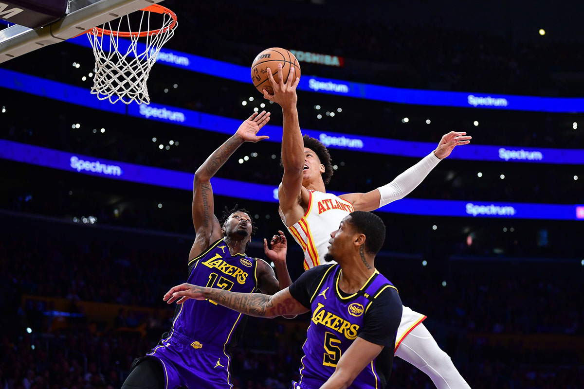 Atlanta Hawks forward Jaylen Johnson (1) drives to the basket against Los Angeles Lakers forward Dorian Finney-Smith (17) and forward Cam Reddish (5) during the first half at Cripto.com Arena. 