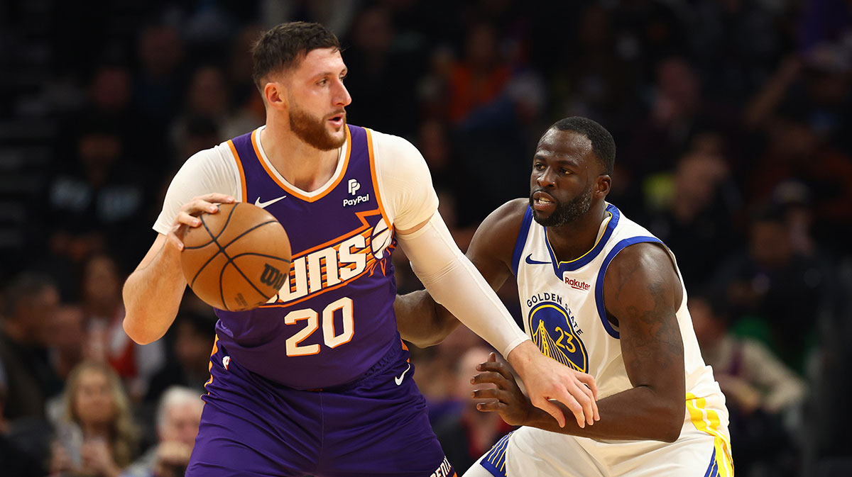 Golden State Warriors Near Draimond Green (23) defends against Phoenix Sun Center Jusuf Nurkić (20) in the footprint center.