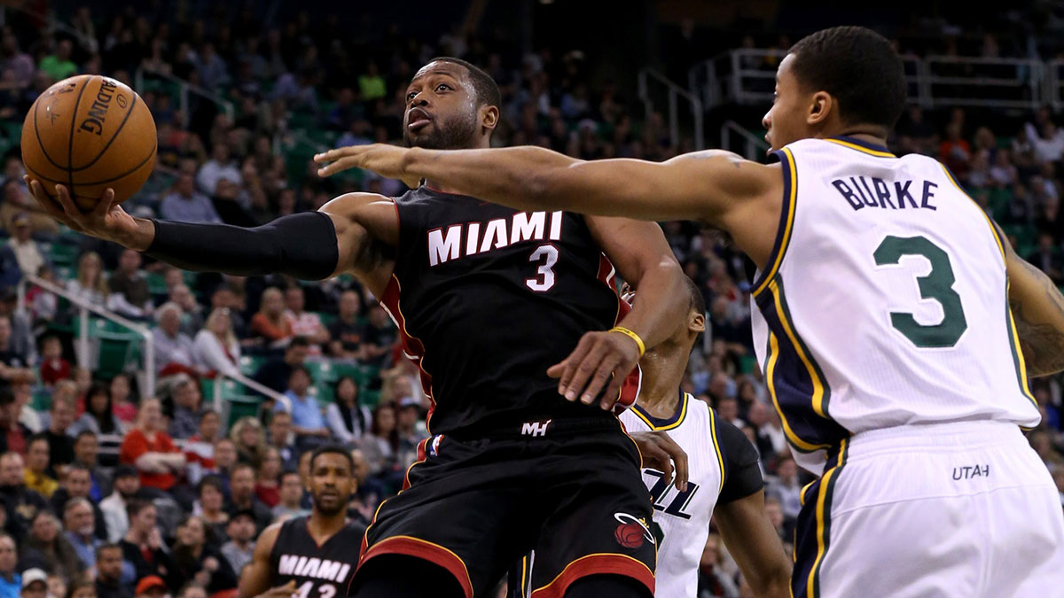 Miami Heat guard Dwyane Wade (3) lays the ball up to the basket while being guarded by Utah Jazz guard Trey Burke (3) during the second quarter at EnergySolutions Arena.