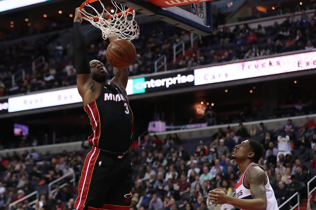 Miami Heart Guard Dviane Wade (3) Dunks The Ball As Washington Vizards Guard Bradley Beal (3) looks at the first quarter in the capital of those arena.