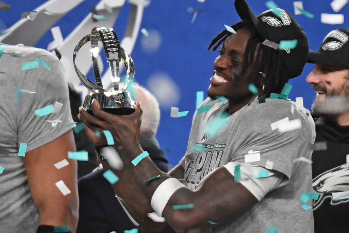 Philadelphia Eagles wide receiver A.J. Brown (11) holds the NFC Championship trophy after defeating the Washington Commanders in the NFC Championship game at Lincoln Financial Field.