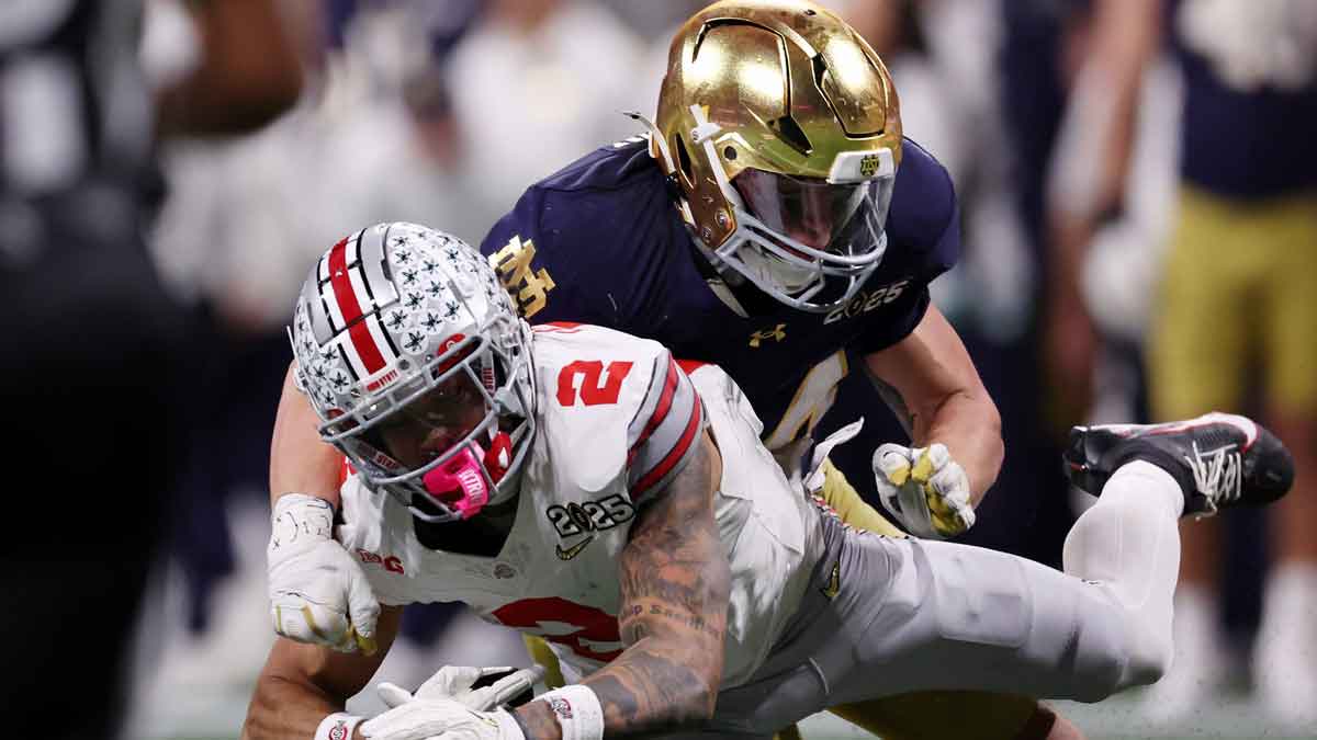 Notre Dame Fighting Irish linebacker Drayk Bowen (34) tackles Ohio State Buckeyes wide receiver Emeka Egbuka (2) during the second half the CFP National Championship college football game at Mercedes-Benz Stadium.