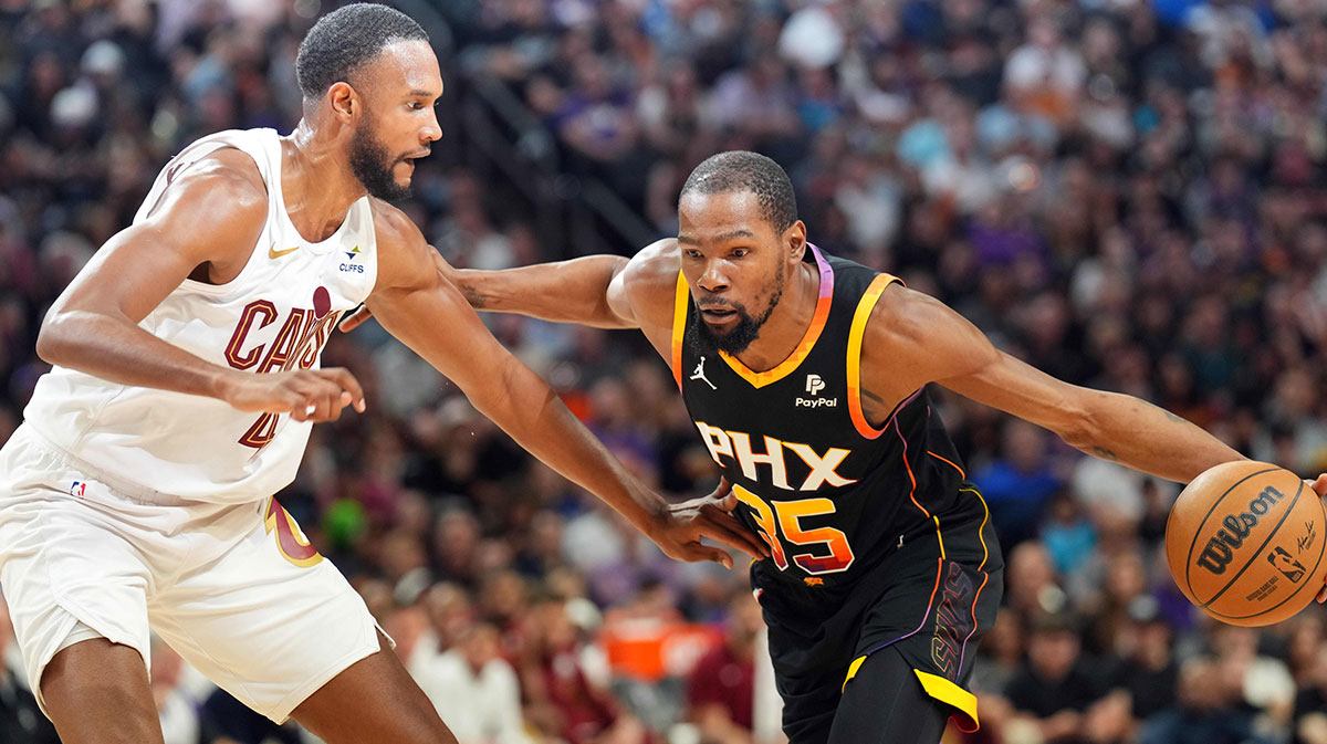 Phoenix Suns forward Kevin Durant (35) dribbles against Cleveland Cavaliers forward Evan Mobley (4) during the first half at the Footprint Center.