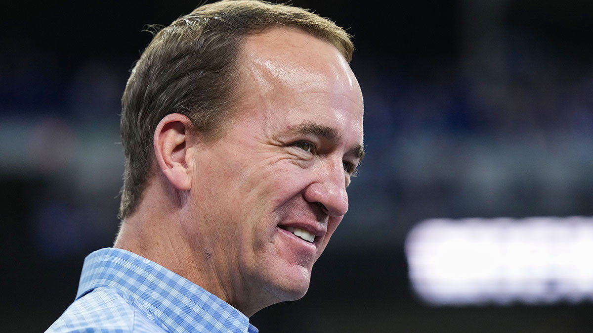 Former Indianapolis Colts player Peyton Manning talks to former teammates and friends on the field Sunday, Oct. 20, 2024, ahead of the game against the Miami Dolphins at Lucas Oil Stadium in Indianapolis. Peyton Manning, Bud Light